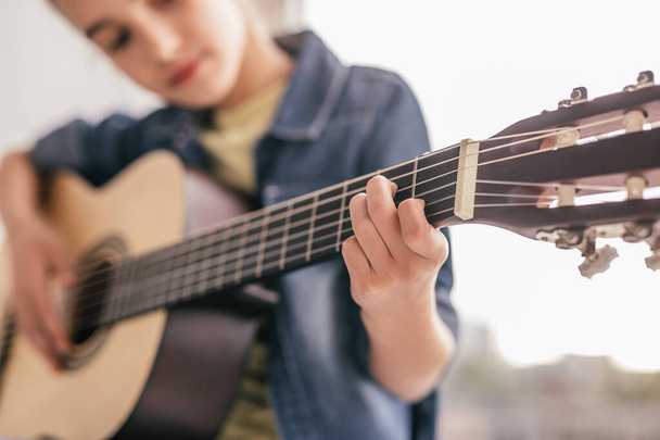 Blurred kid learning to play guitar - Foto, imagen