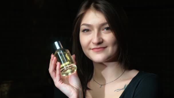 Portrait of a beautiful girl with a perfume bottle - Footage, Video