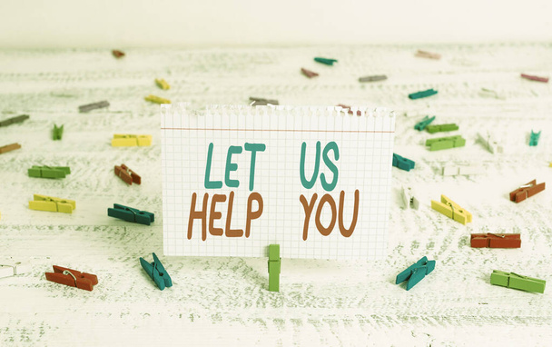 Handwriting text writing Let Us Help You. Concept meaning Offering a service to someone to help him in his necessity Green clothespin white wood background colored paper reminder office supply. - Photo, Image