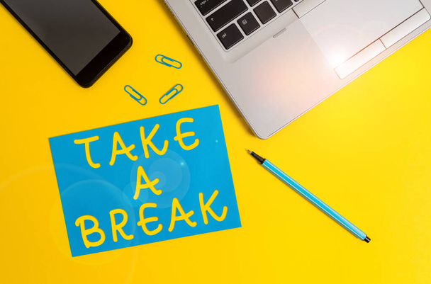 Conceptual hand writing showing Take A Break. Business photo showcasing Resting Stop doing something recreation time get out of work Trendy open laptop smartphone marker paper sheet clips. - Photo, Image