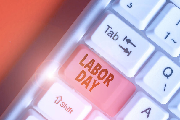 Schrijfbriefje met Labor Day erop. Bedrijfsfoto met een jaarlijkse vakantie om de prestaties van de werknemers te vieren. - Foto, afbeelding