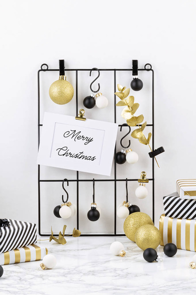 Trendy fashionable christmas decoration with gifts, greeting card and mesh board - Photo, Image