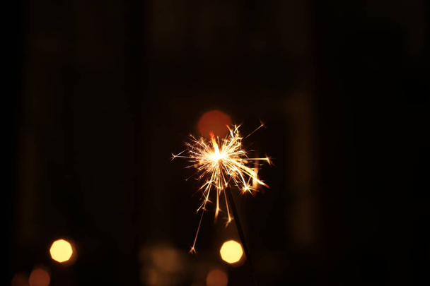 festive christmas background bokeh garland and sparkling sparkler - Photo, Image