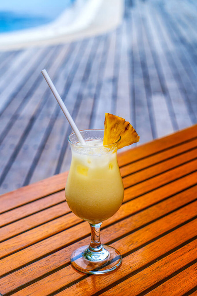 A glass of cold cocktail on a table on the beach in a restaurant - Photo, Image