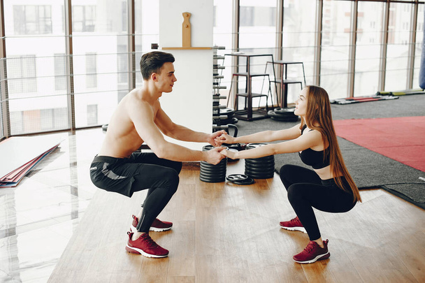Sports couple in a morning gym - Фото, зображення