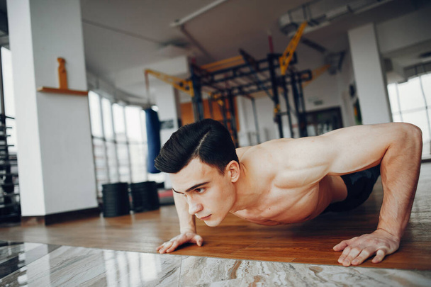 Sports man in a morning gym - Фото, изображение