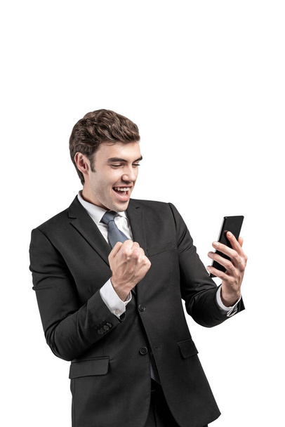 Happy businessman with phone celebrating, isolated - Fotoğraf, Görsel
