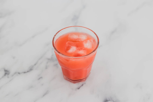 happy hour concept, glass of orange pink juice or cocktail with  - Фото, зображення