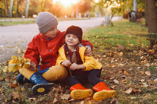 Happy children resting in autumn park - 写真・画像