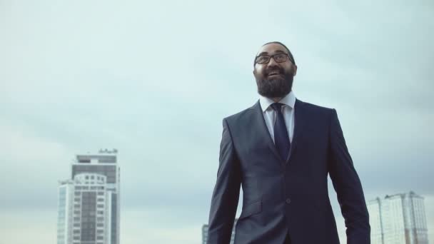 Successful businessman throwing handbag and making winner gesture, inspiration - Video, Çekim