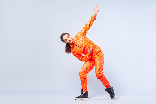 Full length portrait of positive energetic teen girl dancing hip - Fotó, kép