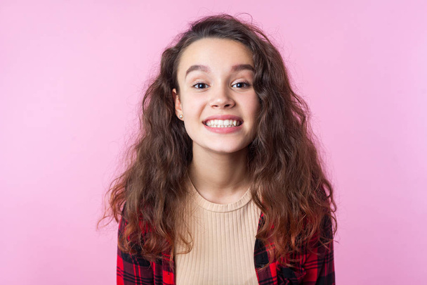 Portrait of excited happy teenage girl showing beautiful toothy  - Fotografie, Obrázek