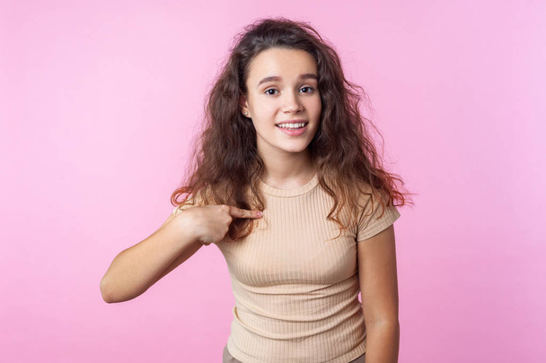 Portrait of lovely teenage girl smiling at camera and pointing a - Φωτογραφία, εικόνα