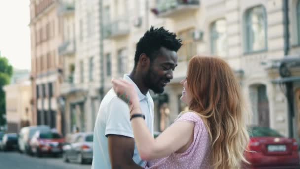 Happy young couple in love hugs on the street in the city on a summer day - Filmmaterial, Video