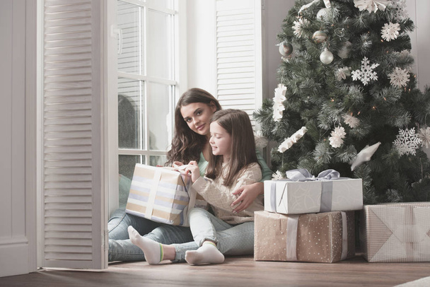 Mother and daughter unpack christmas gift - Photo, Image