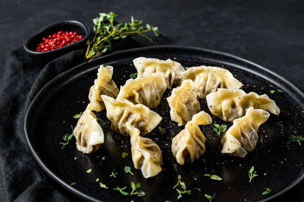 Japanese gyoza stuffed with meat. Black background. Top view - Foto, afbeelding