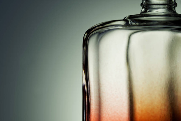 Rózsaszín és piros átlátszó parfümpalack szürke gradiens háton - Fotó, kép
