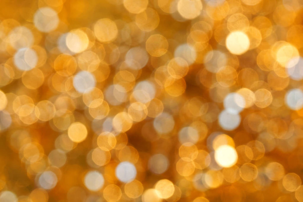 Defocus show. Festive golden lights on a dark background. Night  - Photo, Image