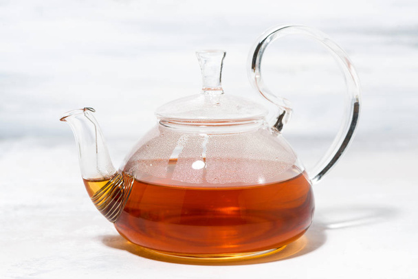 tea in a glass teapot on a white background - Fotoğraf, Görsel