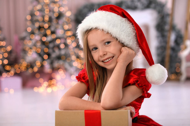 Cute little child with Christmas gift at home - Fotografie, Obrázek