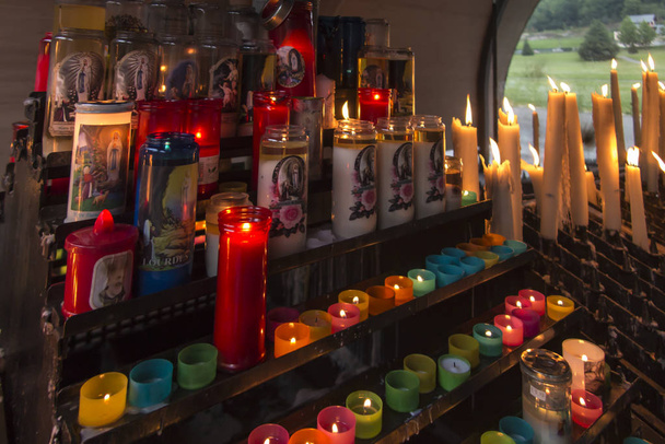 lit candles at the Marian shrine in Lourdes - Photo, Image