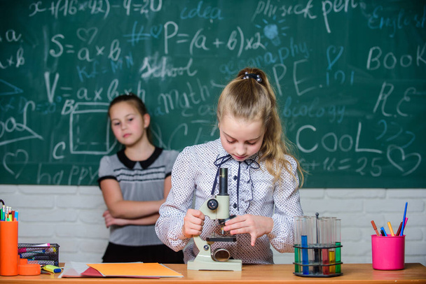 Educational experiment. Back to school. School classes. Girls study chemistry in school. Biology and chemistry lessons. Theory and practice. Observe chemical reactions. Formal education school - Fotó, kép