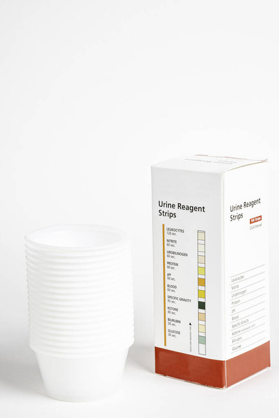 Urine Strips Box And A Stack Of Plastic Containers - Photo, Image