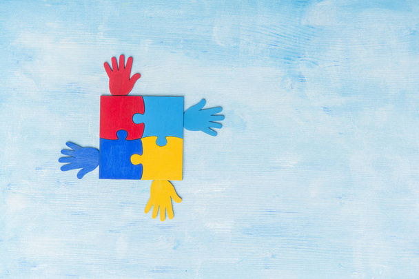 Colorfull puzzles piece on blue background. World Autism Awareness Day Concept - 写真・画像