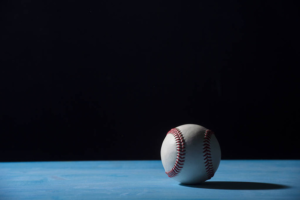 Pelota de béisbol en mesa de madera azul
 - Foto, imagen