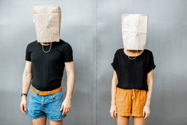 Uomo e donna con sacchetti di carta in testa
 - Foto, immagini