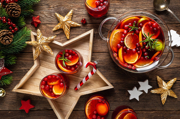 Christmas punch. Festive red hot toddy cocktail, drink with cranberries and citrus fruits - Photo, image