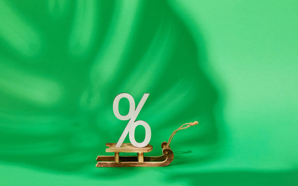 Green Friday concept. Wooden symbol with text Sale on green backround. Shape of percent - Foto, Bild