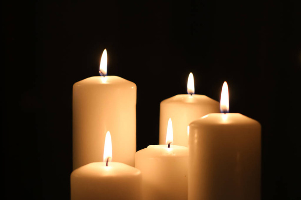 Aromatic vanilla yellow candles set at night, Christmas, New Yea - Foto, afbeelding