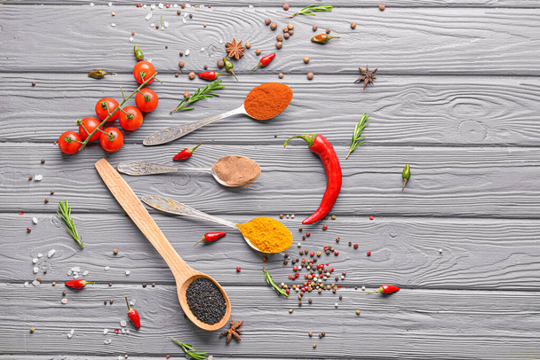 Spoons with different spices on wooden background - Photo, Image