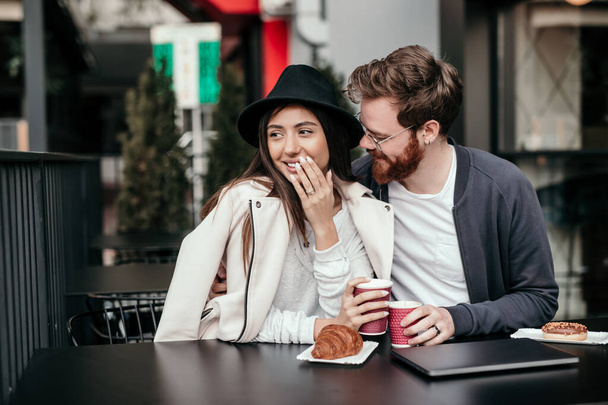 Happy couple enjoying hot drink during date - Valokuva, kuva