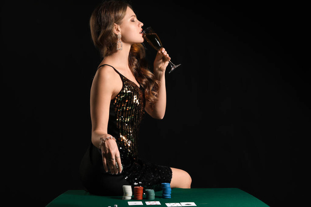 Female player sitting on table in casino - Foto, immagini