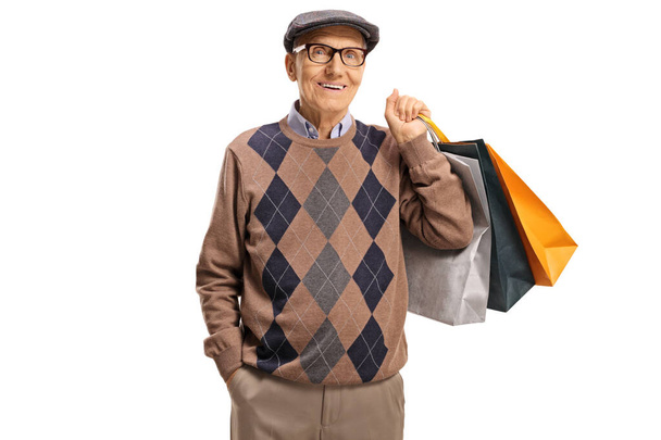 Elderly gentleman carrying shopping bags - 写真・画像