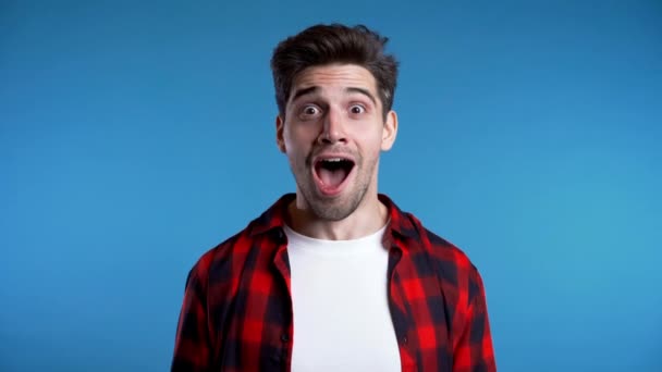 Happy ecstatic man screaming of joy. Excited champion guy celebrating winning. Guy approvingly shakes his head, probably with envy about good news of interlocutor - Video