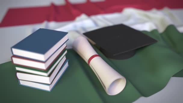 Mezuniyet şapkası, Macar bayrağı üzerine kitaplar ve diploma. Macaristan 'da yüksek öğrenim ile ilgili kavramsal 3d animasyon - Video, Çekim