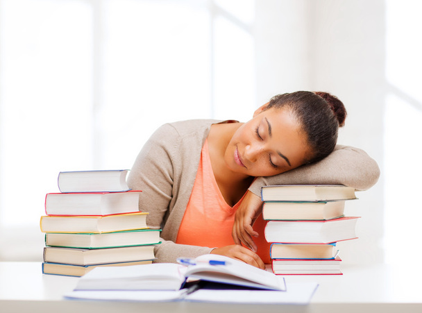 Tired student with books and notes - Foto, Bild