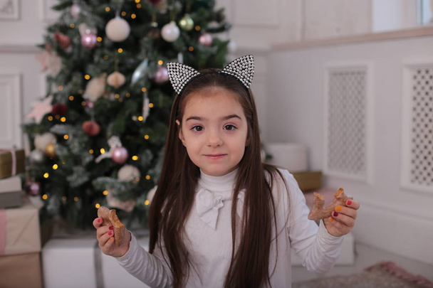 Retrato de Natal de uma menina bonita com longos cabelos loiros em um humor brincalhão retrata emoções diferentes
 - Foto, Imagem