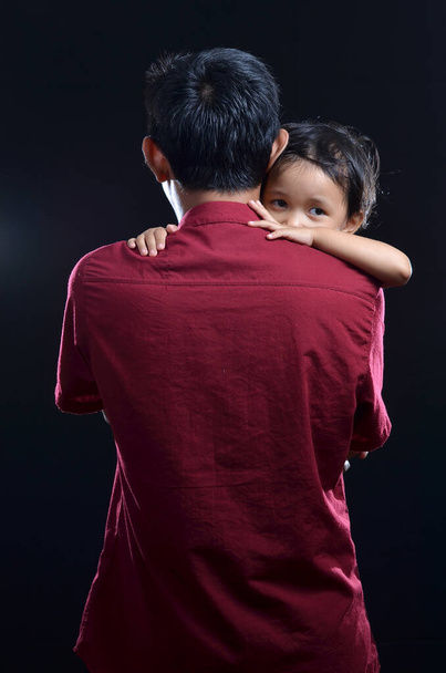 Emotional concept photo on studio. Asian father carrying his child - Photo, Image
