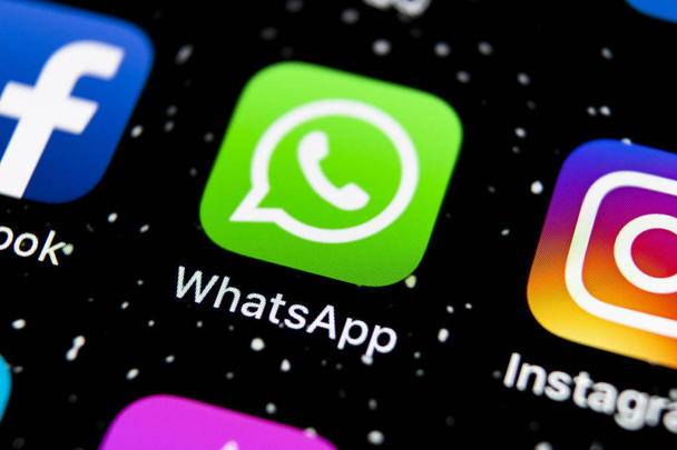 Whatsapp messenger application icon on Apple iPhone X smartphone screen close-up. Whatsapp messenger app icon. Social media icon. Social network - Zdjęcie, obraz