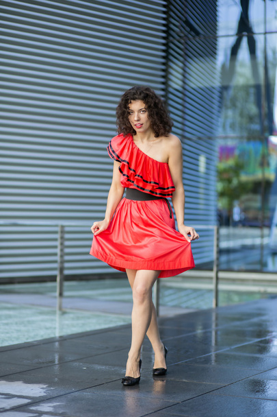 Woman in wet red dress at square - Foto, Imagem