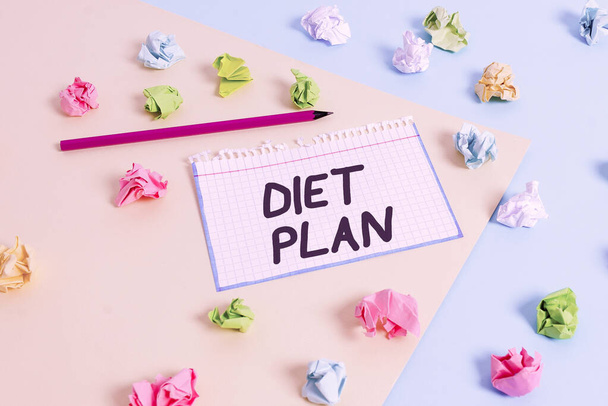 Word writing text Diet Plan. Business concept for detailed proposal for doing or achieving a heathy eating habit Colored crumpled papers empty reminder blue yellow background clothespin. - Fotó, kép