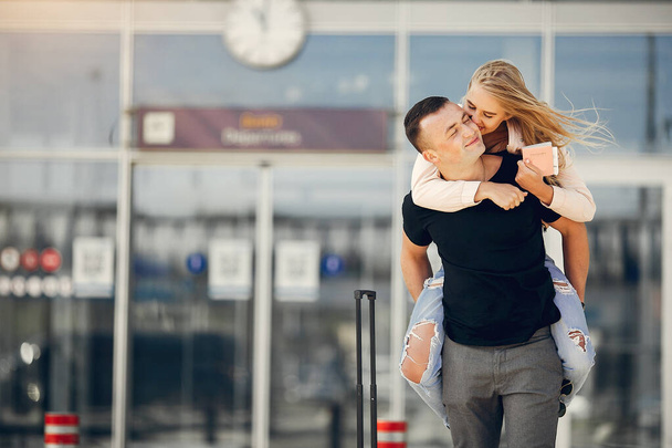 Beautiful couple standing in a airport - Fotoğraf, Görsel
