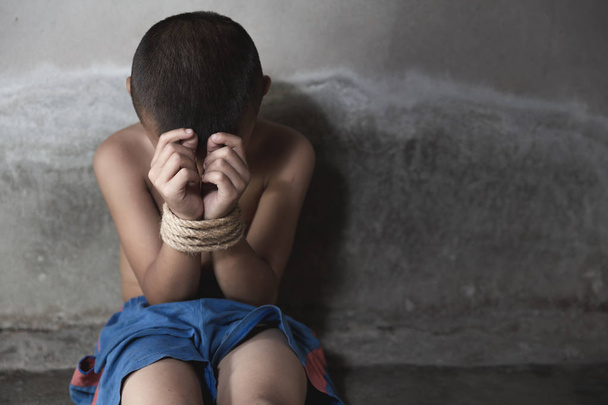 victim child tied up with rope in emotional stress and pain. Sto - Photo, Image