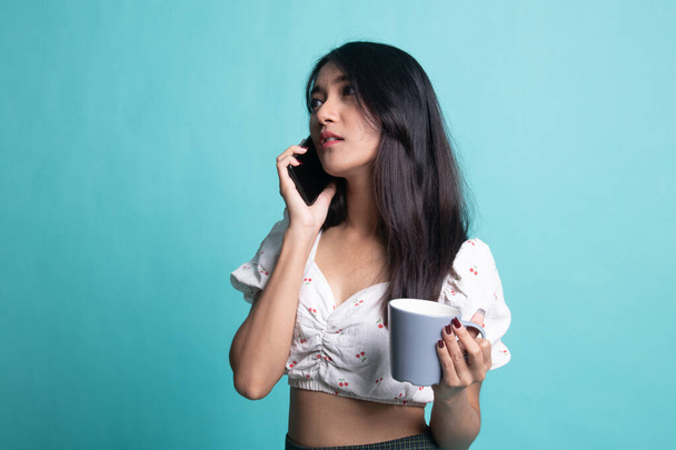  Beautiful young Asian woman announce with megaphone  on cyan background - Foto, immagini