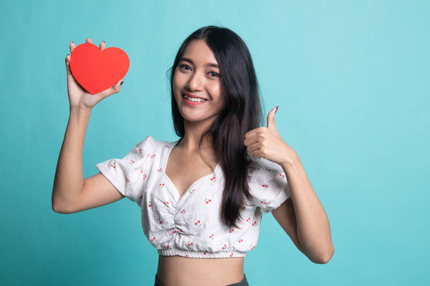 Asian woman thumbs up with red heart. - Foto, imagen