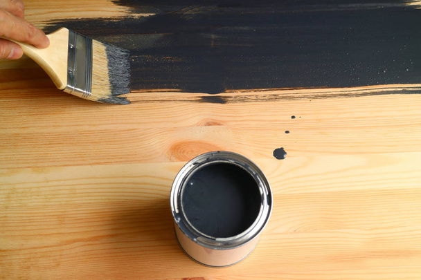 Hand painting the wood plank with dark grey paint - Photo, Image